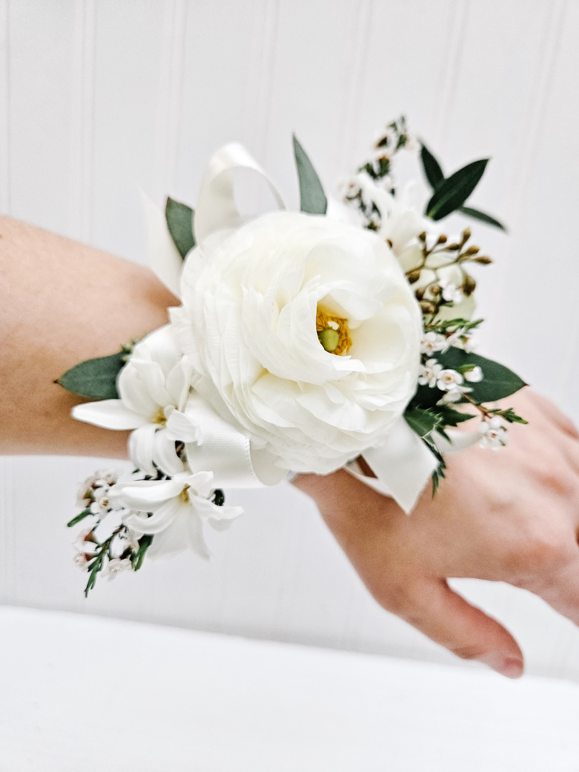 All white toned corsage for prom.
