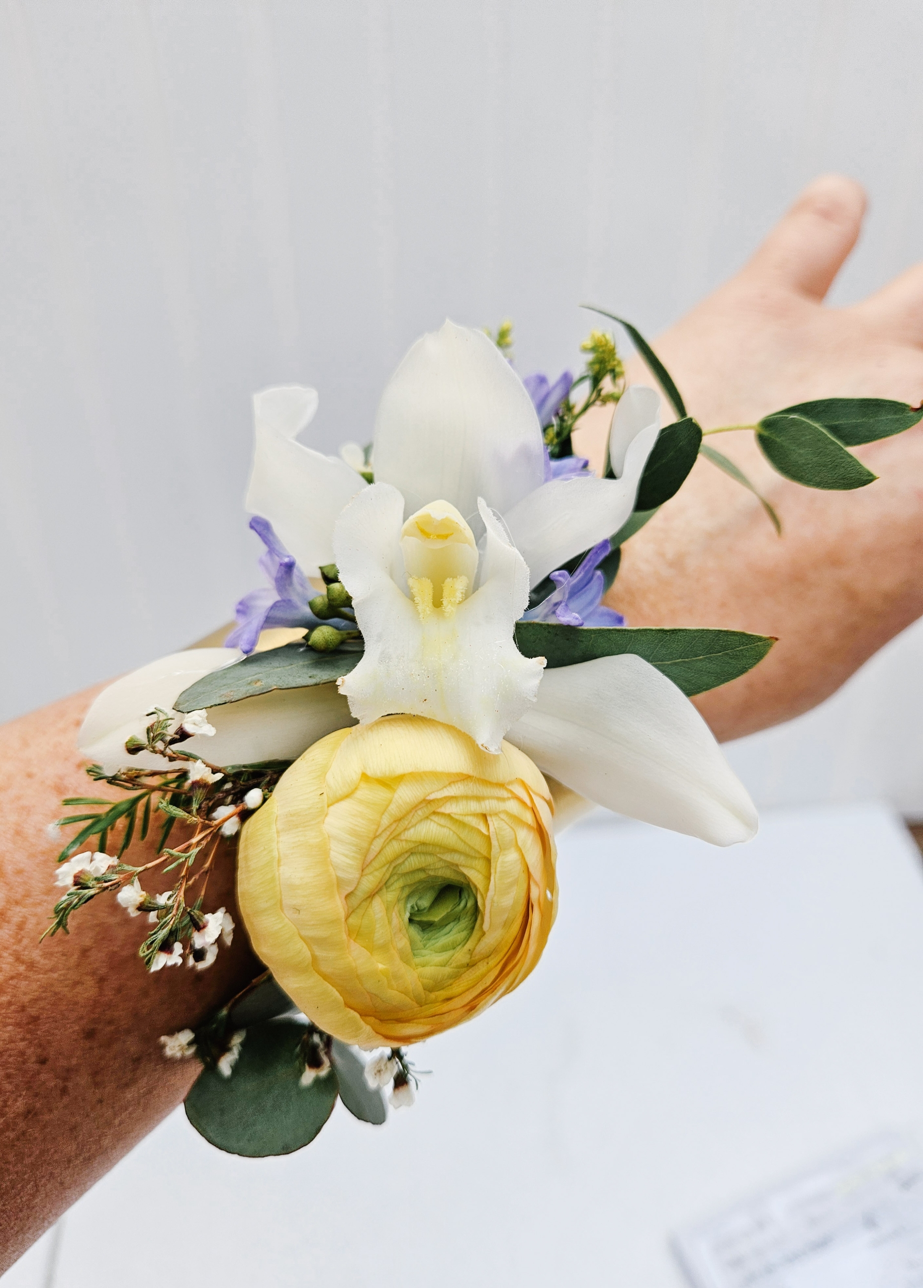 Yellow, white, and blue toned corsage.