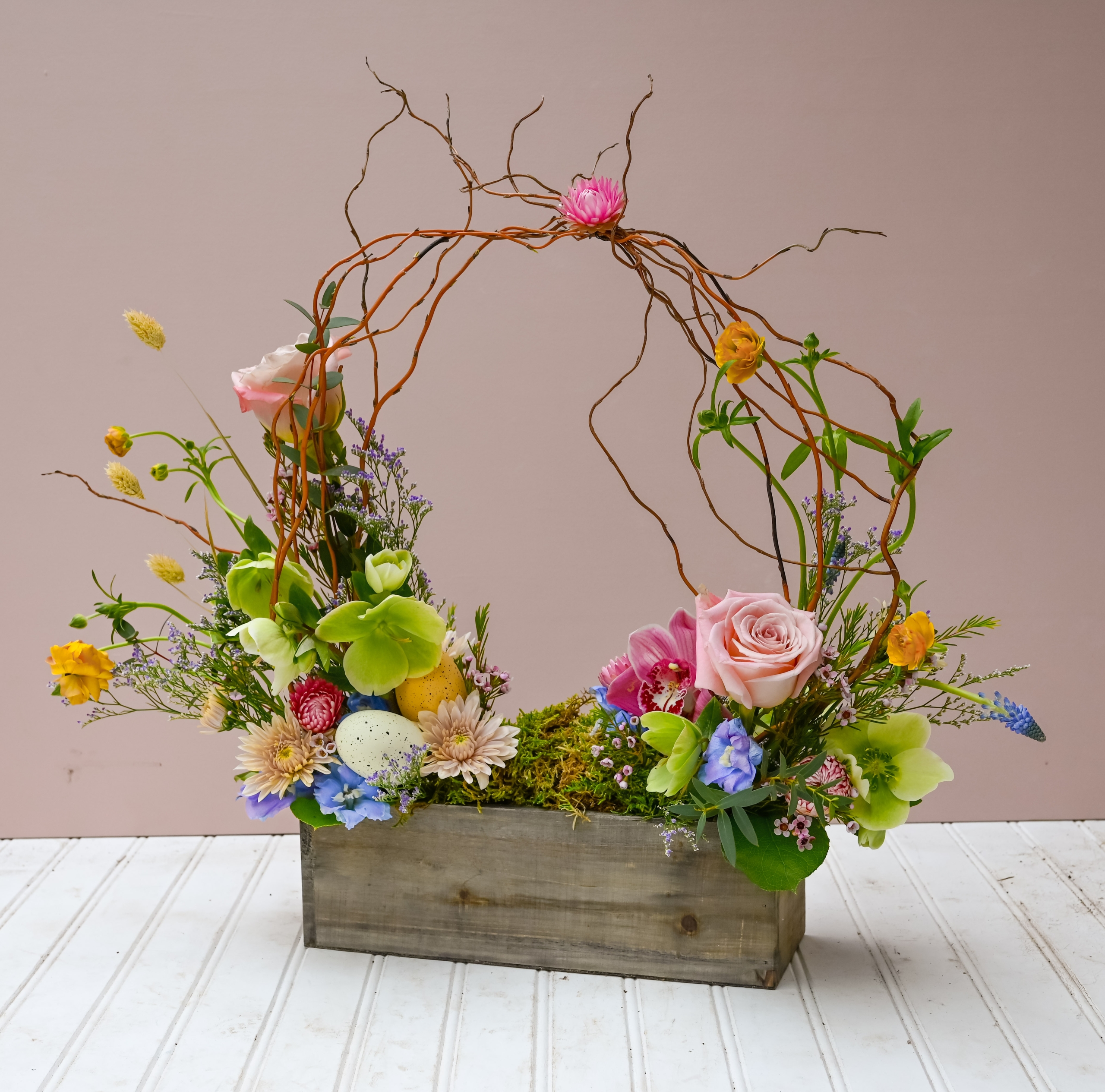 Easter basket inspired bouquet arrangement featuring light pastel florals and moss.