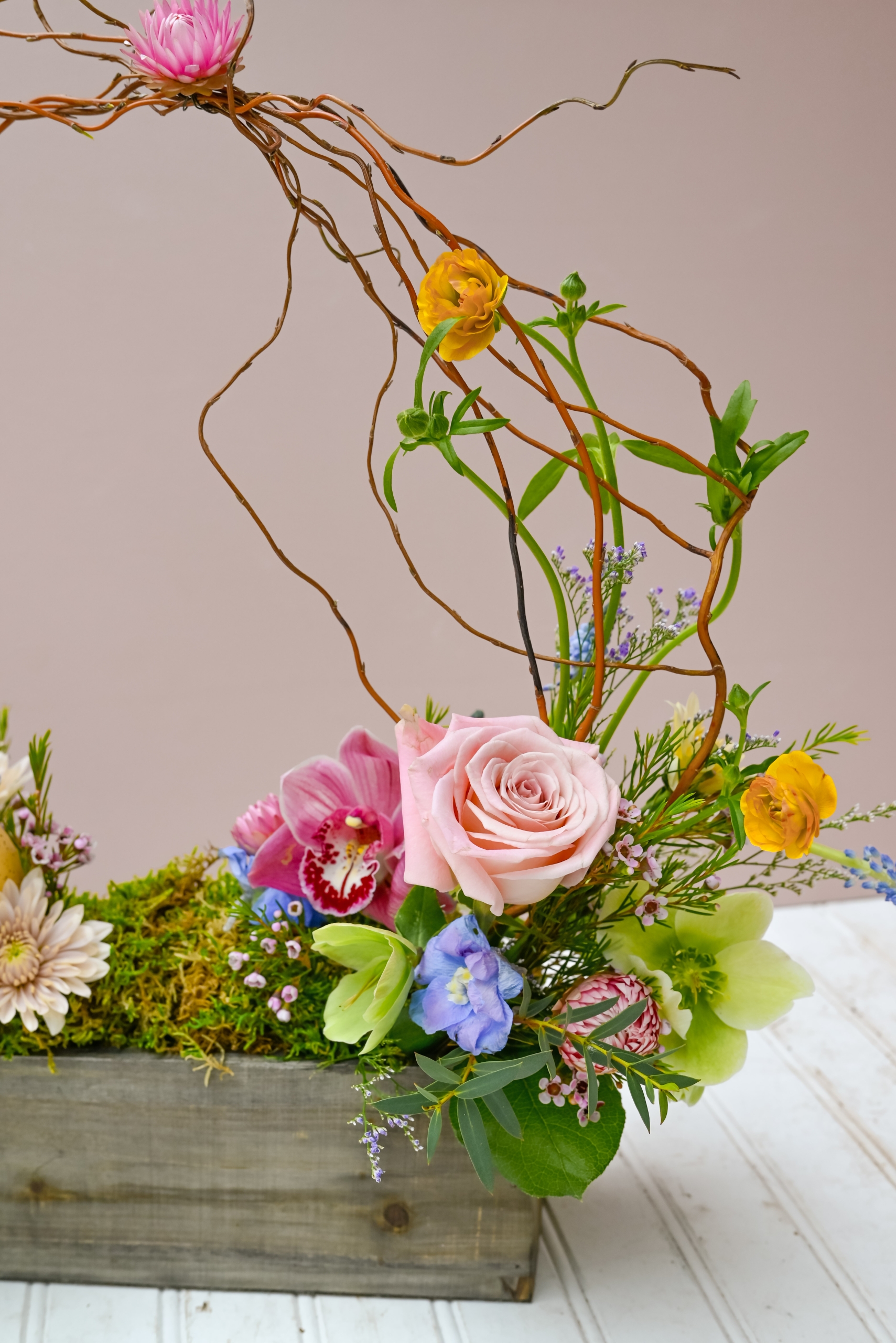 Easter basket inspired bouquet arrangement featuring light pastel florals and moss.