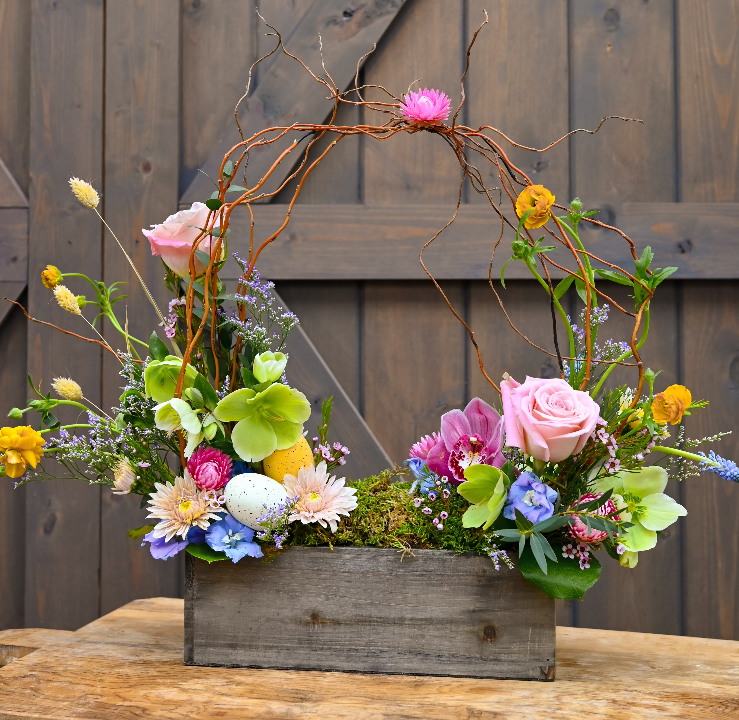 Easter basket inspired bouquet arrangement featuring light pastel florals and moss.