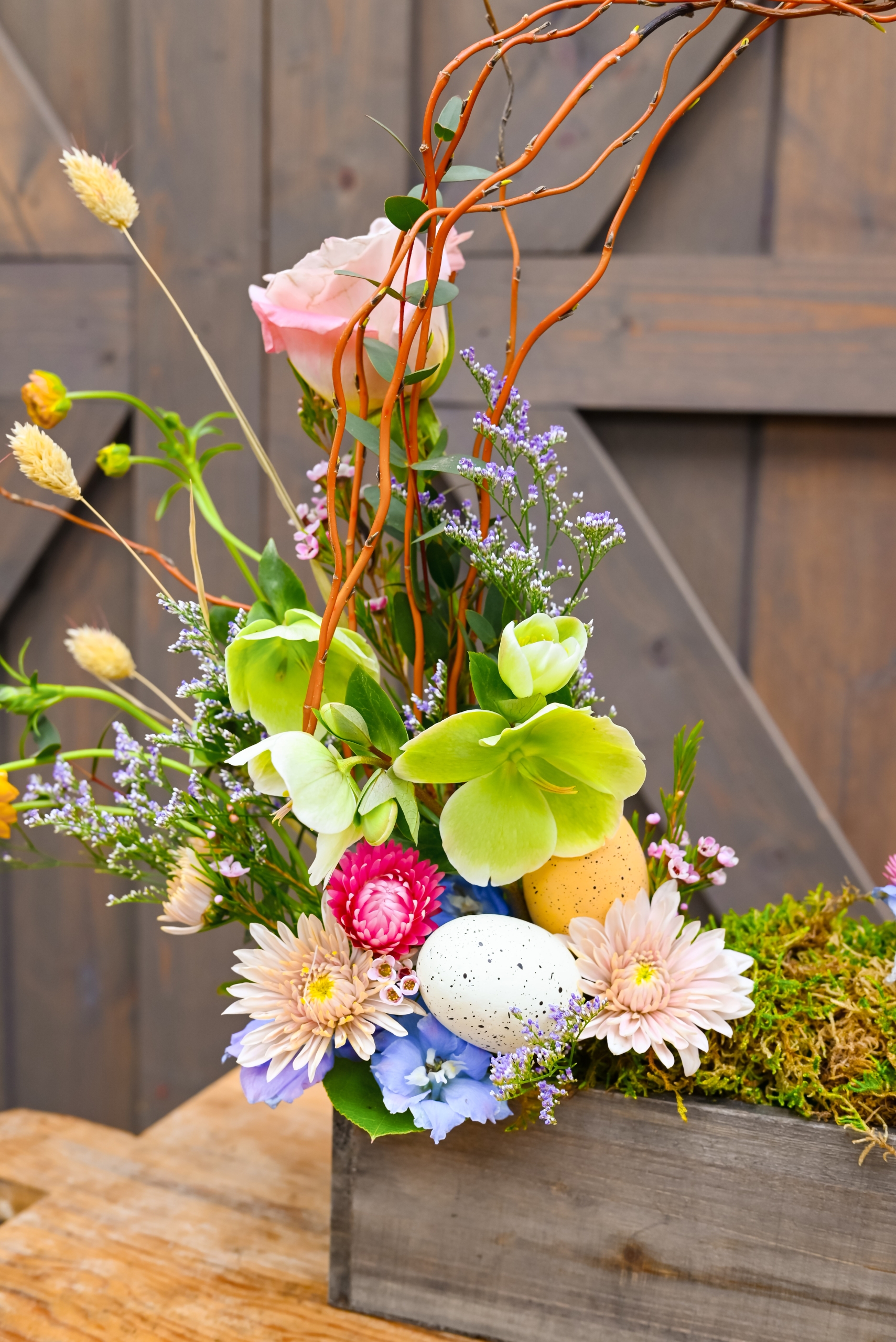 Easter basket inspired bouquet arrangement featuring light pastel florals and moss.