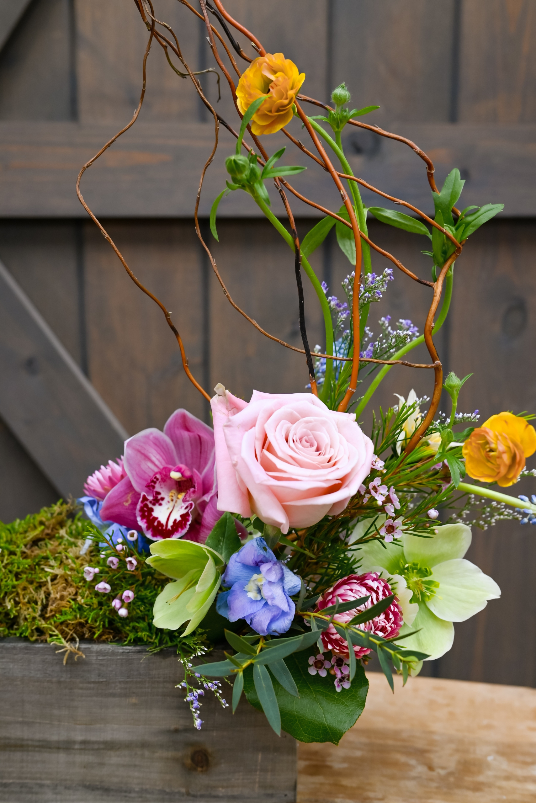 Easter basket inspired bouquet arrangement featuring light pastel florals and moss.
